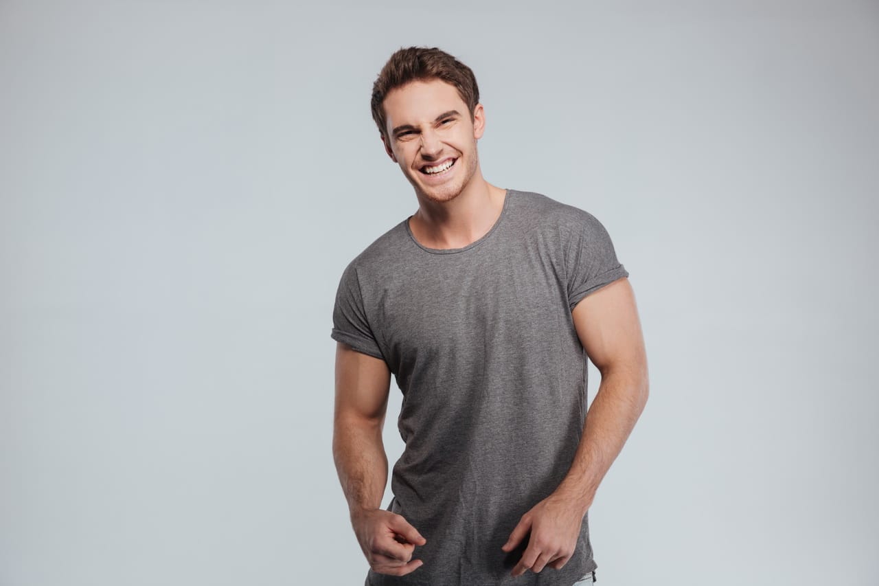 Portrait Of A Handsome Casual Man Standing And Laughing