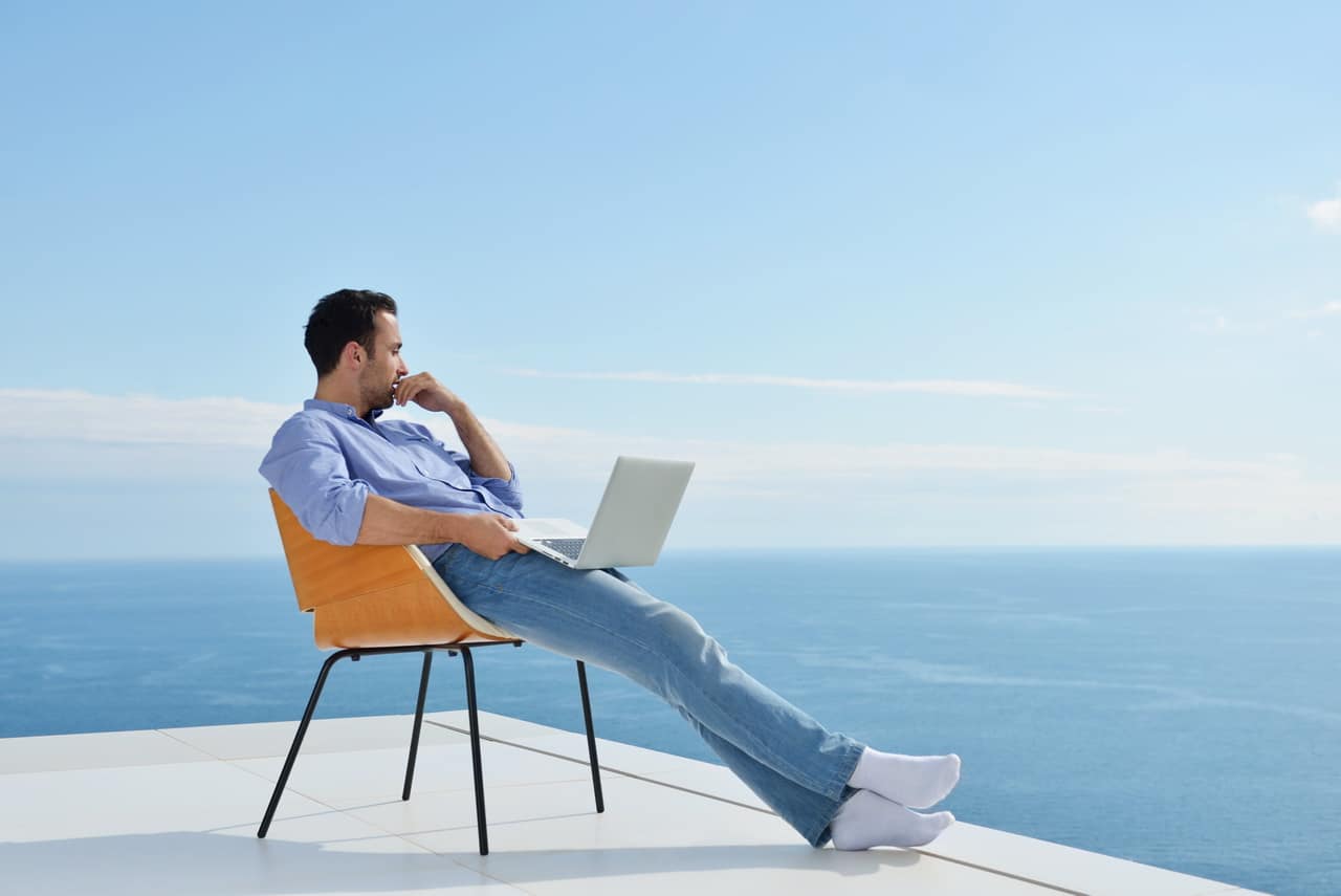 Relaxed Young Man At Home On Balcony