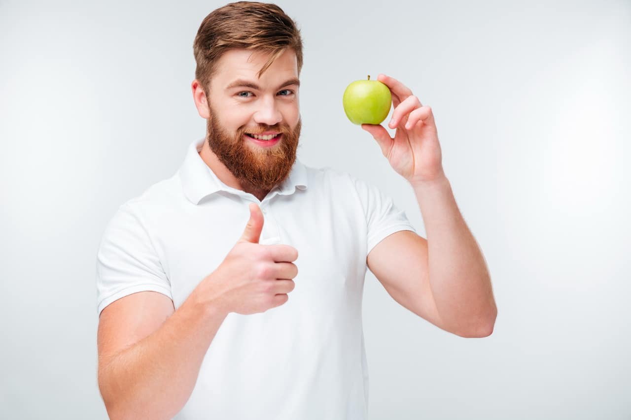 Happy Man Holding Green Apple And Showing Thumbs Up Gesture