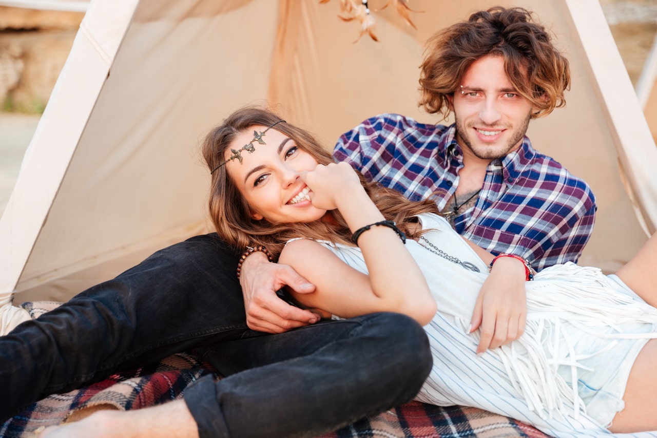 Couple Lying In Teepee On The Beach